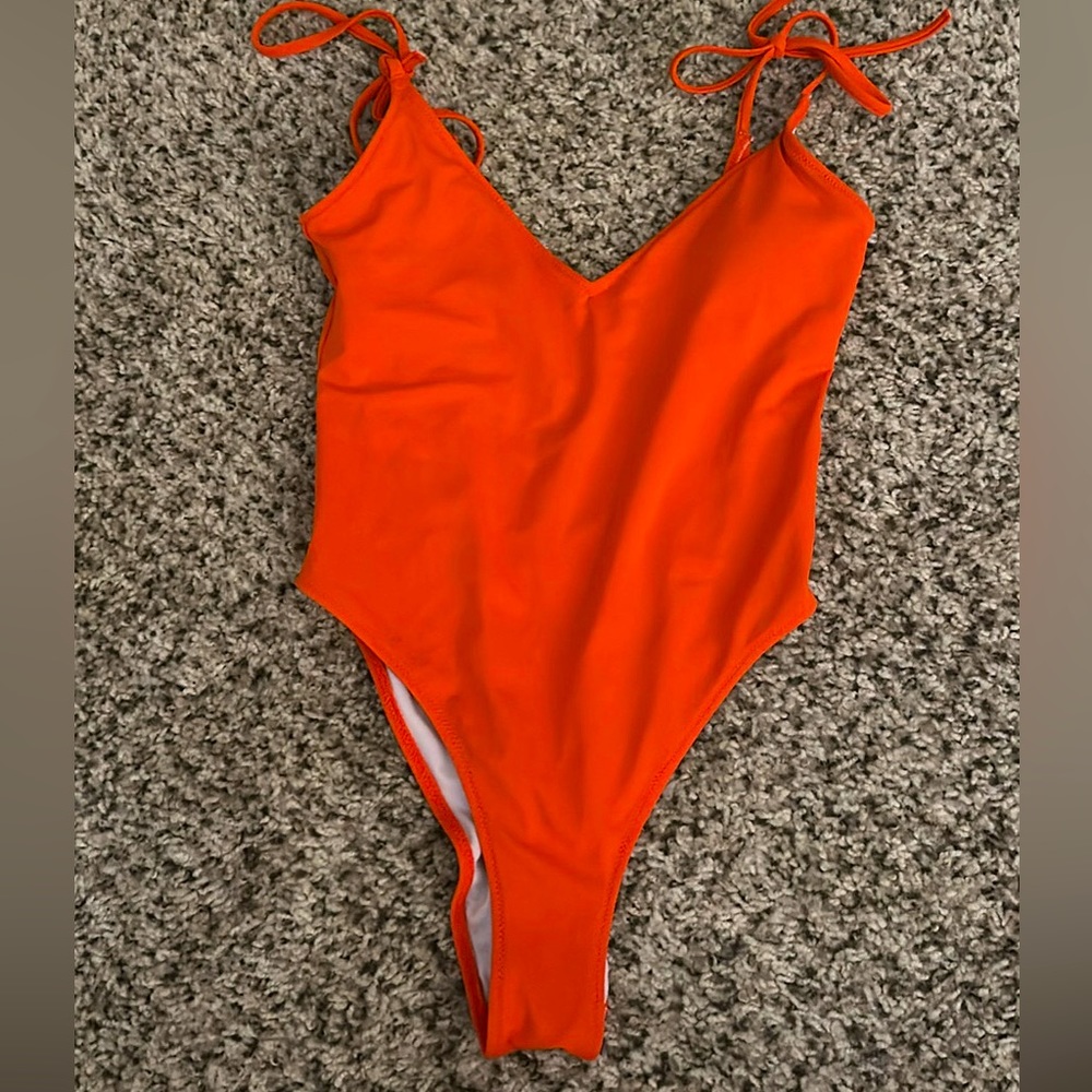 Women’s one piece bathing suit. Color- Bright orange, size xs.